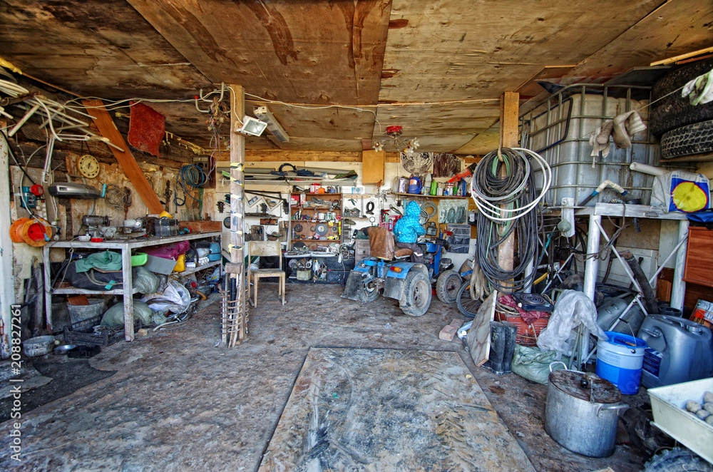 A cluttered shed stuffed with boxes and tools – a messy setup you’ll want to avoid.