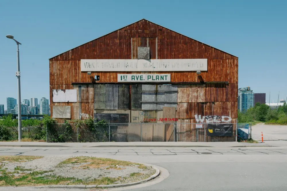 An old corrugated-iron shed stands under a clear blue sky
